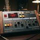 A highly detailed, photorealistic render of a vintage-inspired 'JUNI 1984 CHORUS' desktop effects unit. The device features a sturdy, brushed metal chassis with a deep blue finish, large tactile chrome knobs, and retro-style toggle switches. A small, glow